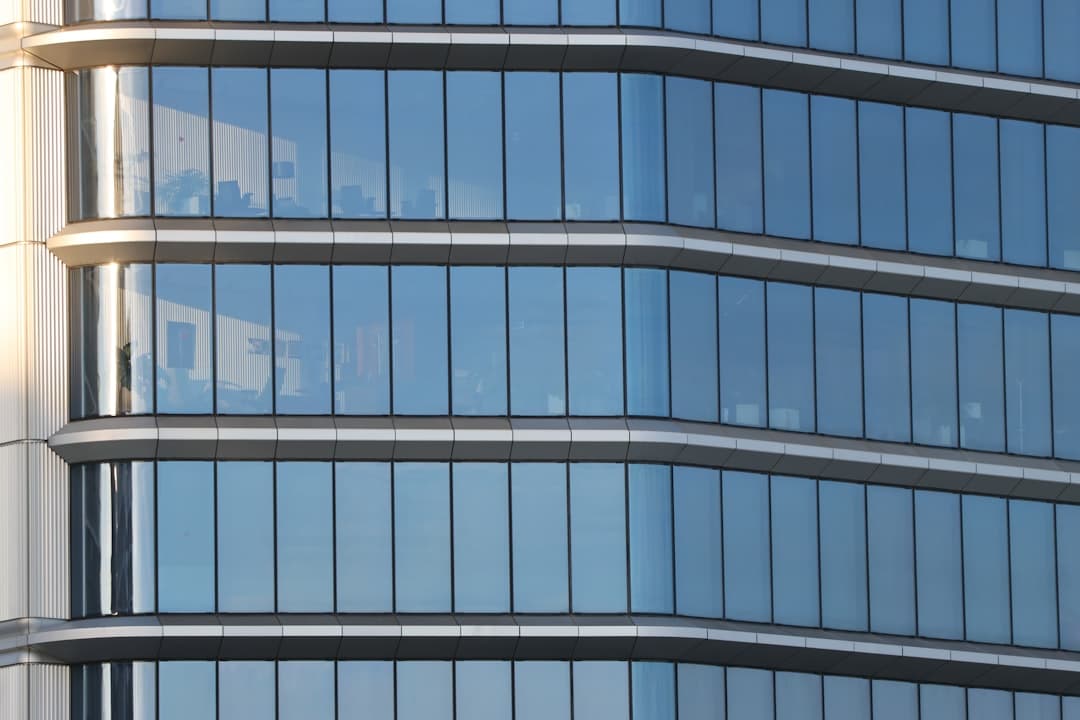 Modern building with glass facade and window treatments